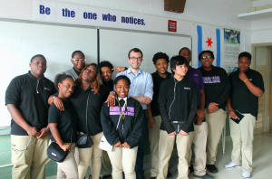 A group of students with the speaker in the center.